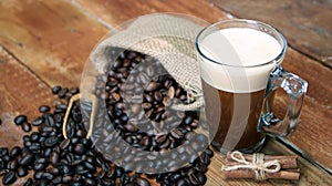 Coffee cup with Coffee beans, burlap sack and with cinnamon sticks