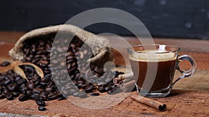 Coffee cup with Coffee beans, burlap sack and with cinnamon sticks