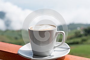 Coffee cup with coffee beans and coffee leaves