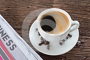 Coffee cup with coffee beans and coffee leaves