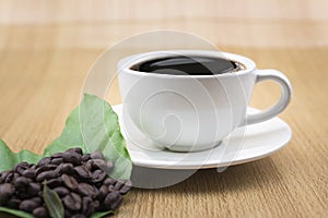 Coffee cup with coffee beans and coffee leaves