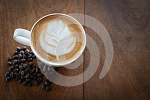 Coffee cup and coffee beans on old wooden background, Top view