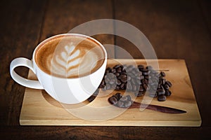 Coffee cup and coffee beans on old wooden background, Top view