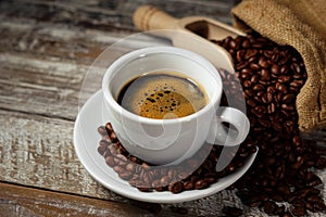 Coffee Cup And Coffee Beans On Rustic Table