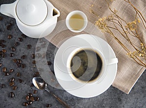 Coffee cup and coffee beans on table