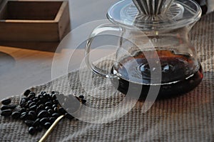 Coffee cup and coffee beans on table, black coffee in cup, americano coffee