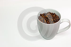 Coffee cup with coffee beans on white space