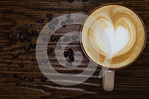 Coffee cup,coffee beans and wood table top view