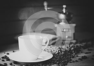 Coffee cup with coffee beans on a wooden table