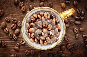 Coffee cup with coffee beans on wooden table