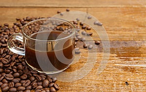 Coffee cup and coffee beans on a wooden table