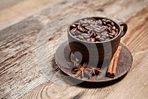 Coffee cup with coffee beans on wooden table