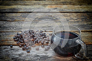 Coffee cup and coffee beans on a wooden table