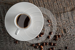 Coffee cup and coffee beans on wooden table background top view