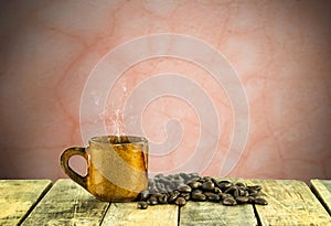 Coffee cup and coffee beans on wooden table with grunge background