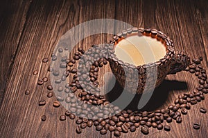 Coffee cup with coffee made from coffee beans wooden table.