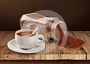 Coffee cup and coffee poured from a jar