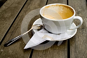 Coffee cup with coffee stains have not washed the cup placed on the wooden table