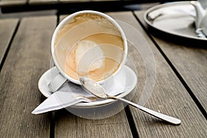 Coffee cup with coffee stains have not washed the cup placed on the wooden table