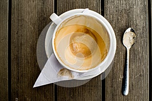 Coffee cup with coffee stains have not washed the cup placed on the wooden table