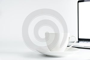 Coffee Cup and computer desktop on white office desk table with