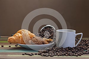 Coffee cup and cookies with beans