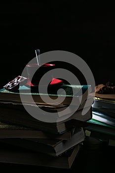 The coffee Cup and cookies and chocolate on stack of books