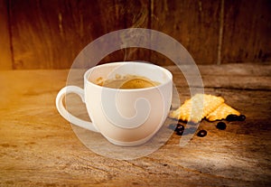 Coffee cup with crackle food on wooden background or shop