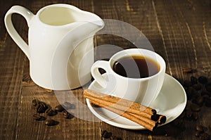 coffee cup, creamer with cinnamon the scattered coffee beans/coffee cup, creamer with cinnamon the scattered coffee beans on