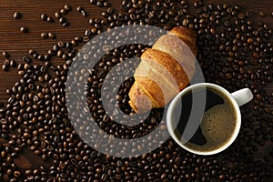 Coffee cup with croisant photo