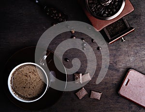 Coffee cup on a dark wooden background