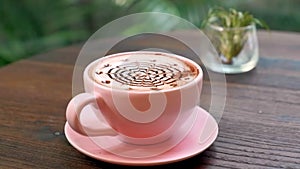 Coffee Cup and Decorative Tropical Plant in Glass on Restaurant Table, Sunlights