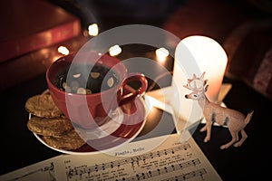 Coffee cup and deer figurine in cozy Christmas still life