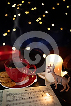 Coffee cup and deer figurine in cozy Christmas still life. Vertical shot