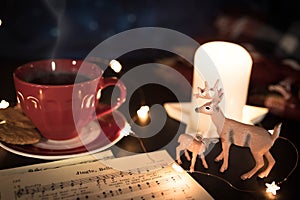 Coffee cup and deer figurines in cozy Christmas still life