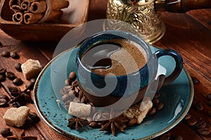 Coffee cup, demerara brown sugar cubes ,  Ñezve and beans on old kitchen table