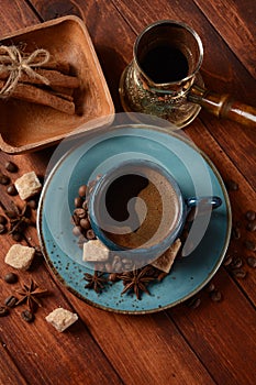 Coffee cup, demerara brown sugar cubes ,  Ñezve and beans on old kitchen table