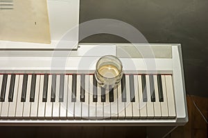 coffee cup on electronic piano