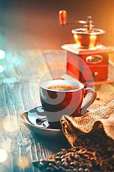 Coffee. Cup of espresso and coffee grinder, roasted aroma Coffee beans on wooden table