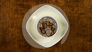 Coffee cup filled with beans stop motion animation turning clockwise topview