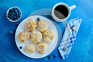 Coffee cup and freshly pastries with blueberry photo