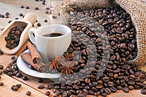 Coffee cup and grains on wooden table