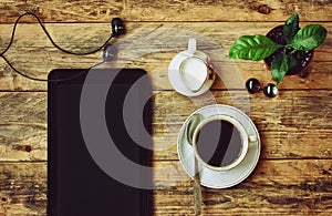 Coffee cup, headphones, flower pot, tablet, jug of milk