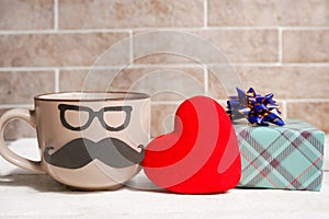 Coffee cup, heart and gift box on wooden table. Father`s day holiday concept