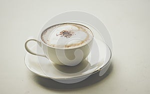 Coffee cup with hearts on old table photo