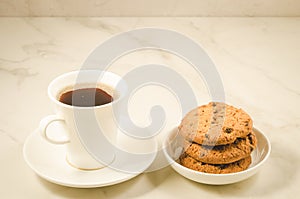 coffee cup and homemade cookies with chocolate/coffee cup and homemade cookies with chocolate on a marble background, selective