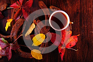 Coffee cup, horseshoes and leaves