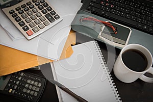 Coffee cup, laptop, Document file , pen , Calculator , notepad a