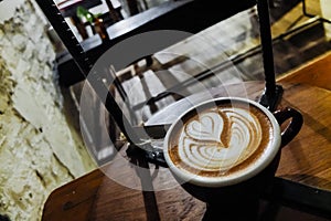 Coffee cup with latte art in cafe