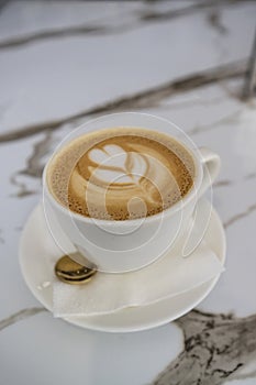 Coffee cup with latte on the table